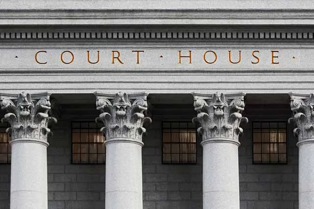 The words Court House carved above a courthouse entrance