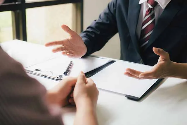 A lawyer explaining a case to a client across a table