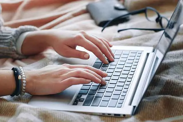 A person typing on a laptop