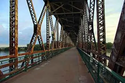 A pedestrian walkway across a steel bridge