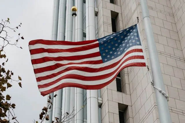 A United States flag flying outside a federal building