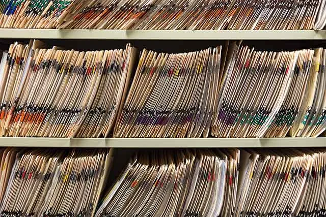 Court case files stacked on office shelves