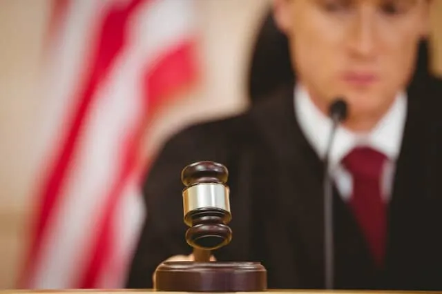 A judge holding a gavel in court