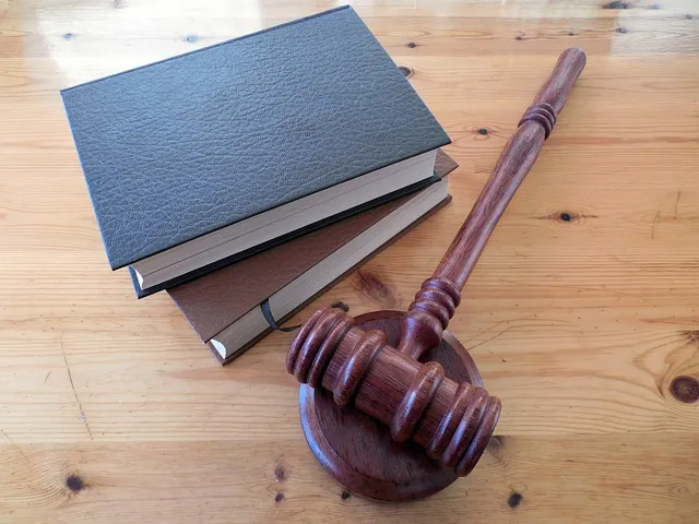 Closed law books and a judge's gavel on a wooden table