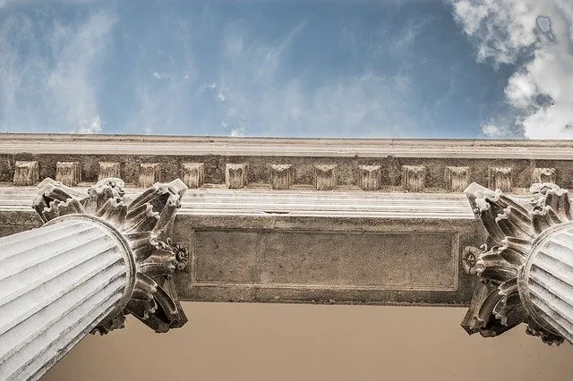 The stone cornice and columns of a courthouse