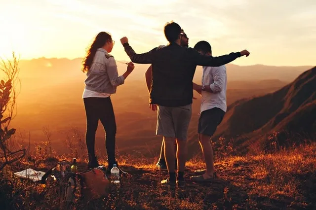 A group of friends outdoors at sunset