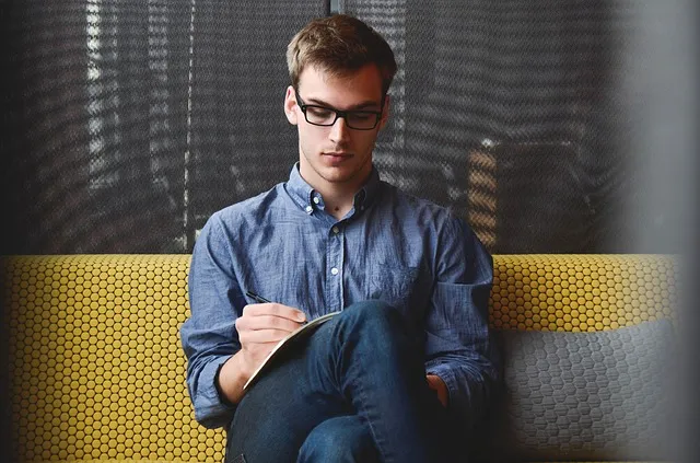 A man filling in a form on a clipboard