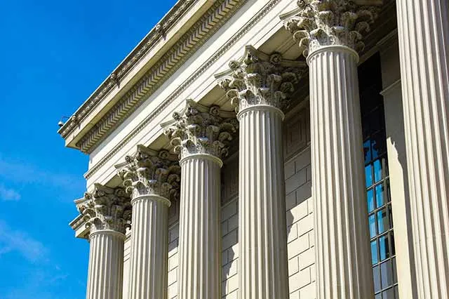 Courthouse columns against a clear sky