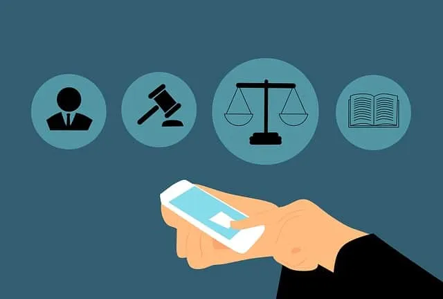 Illustration of legal icons beside a hand holding a phone