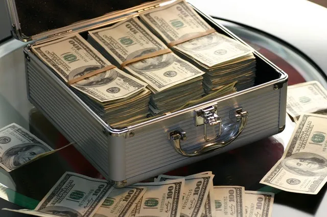 A metal briefcase packed with bundles of cash